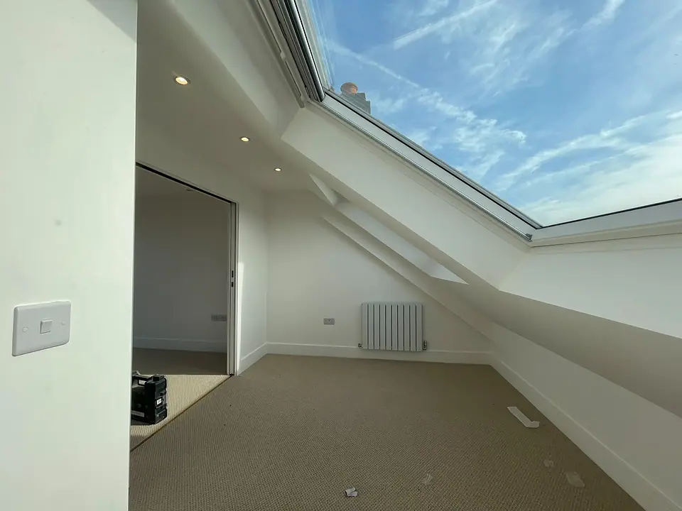 Finished loft room under a large roof window